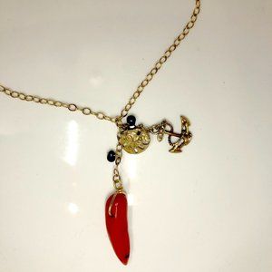 Gold necklace with nautical charms.